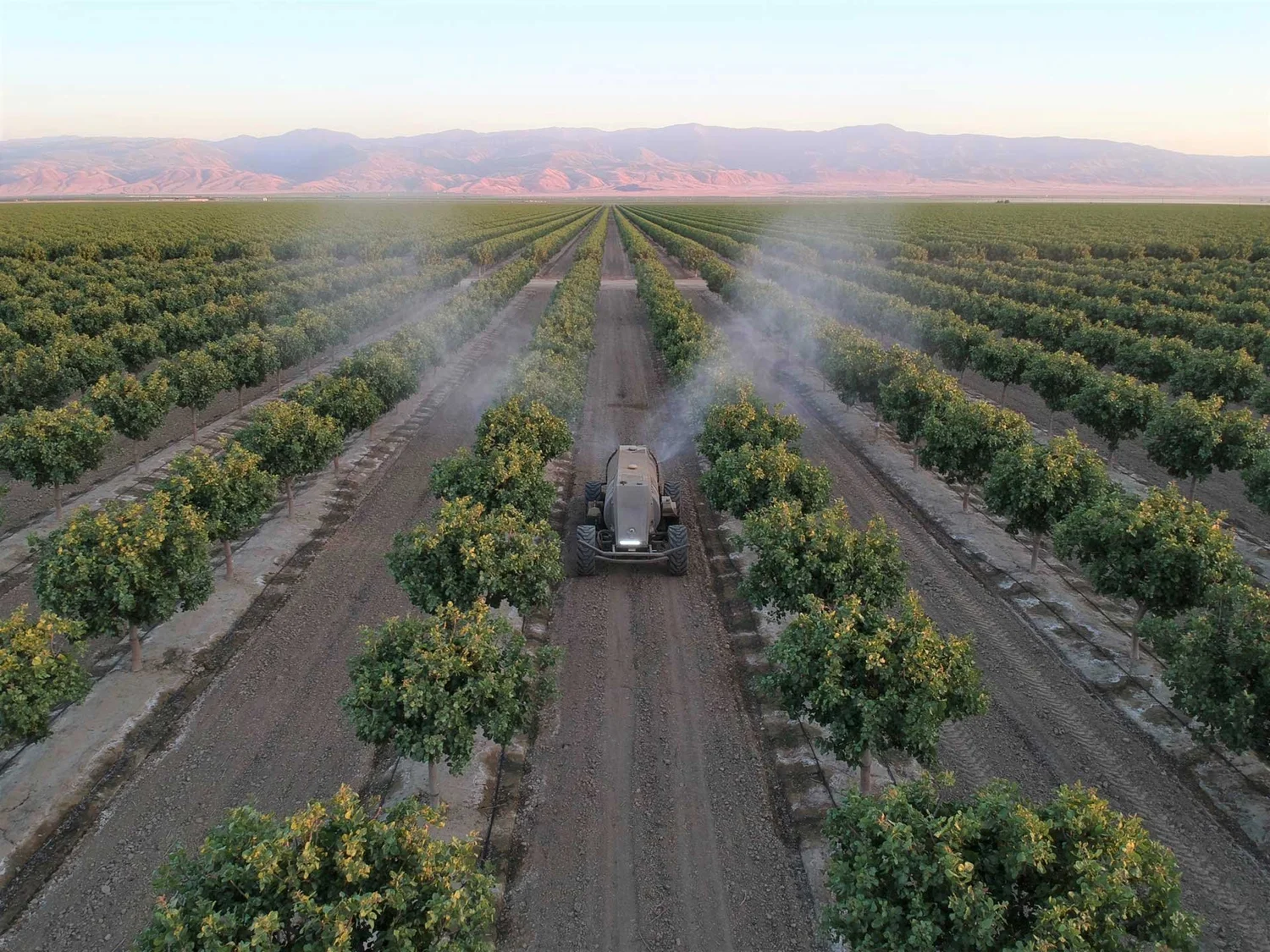 Sprayer applying a foliar feed across a field
