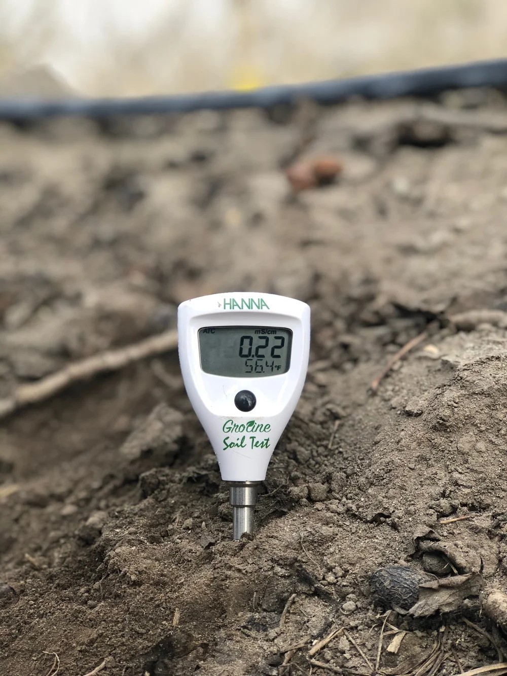 An EC meter measuring soil conductivity